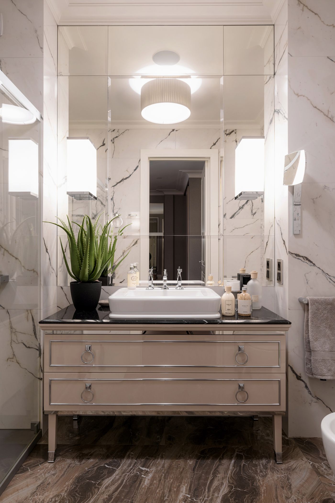 Elegant cream bathroom vanity with warm sconce light
